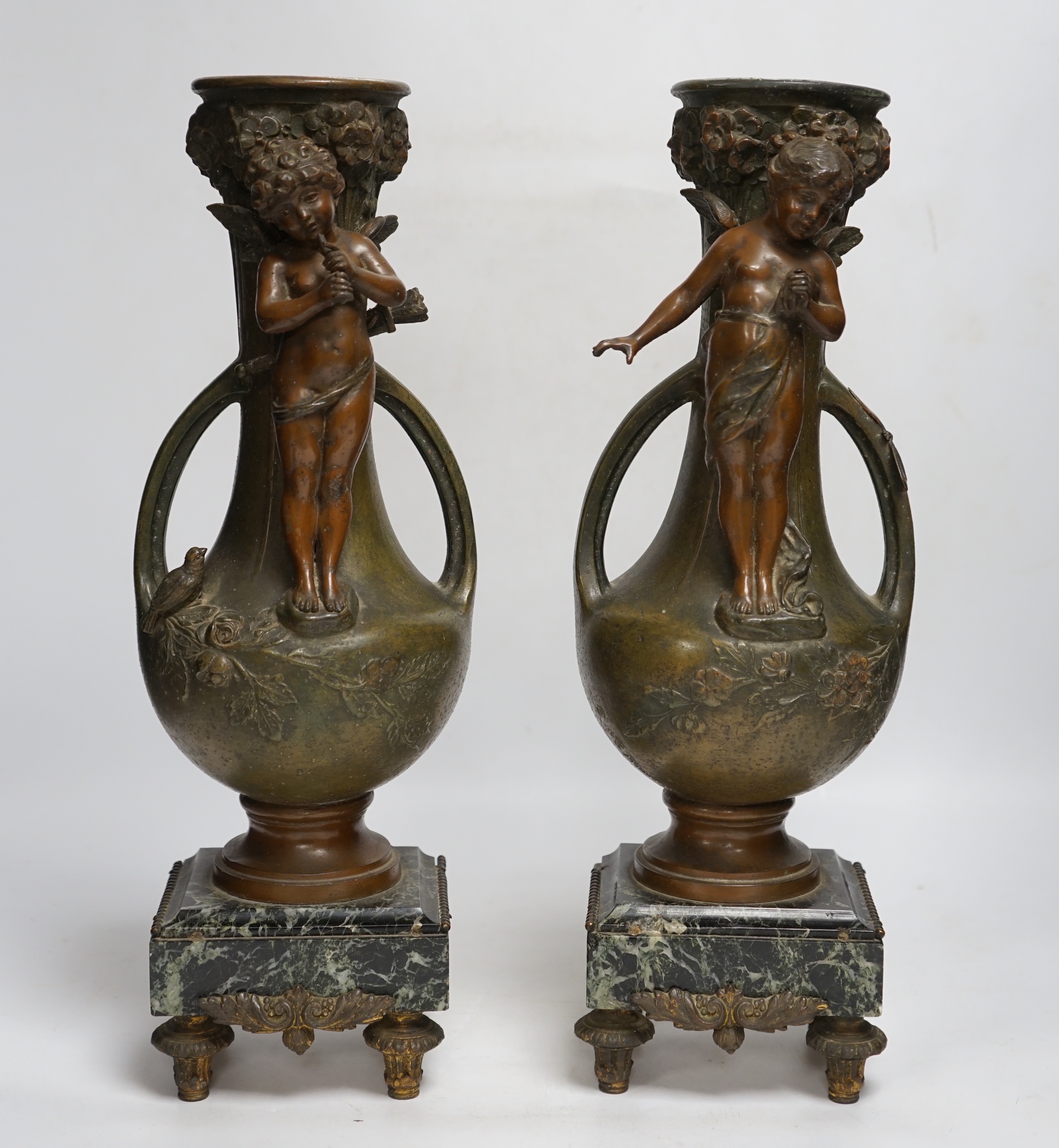 After Hippolyte François-Moreau (1832-1927), a pair of bronzed spelter cherubic vases on marble bases, 42cm